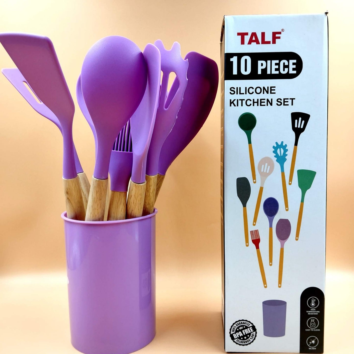 Purple silicone kitchen utensils in a cup with TALF packaging on a beige background